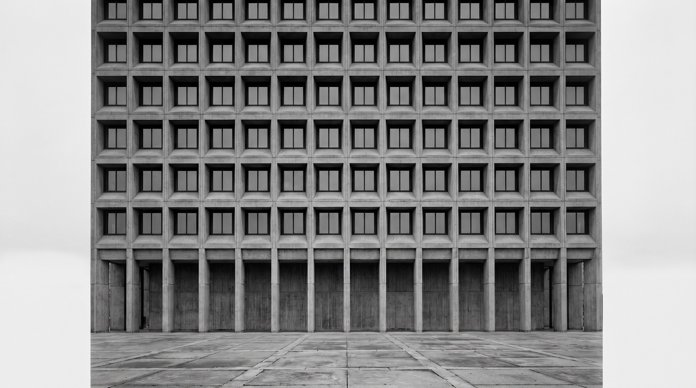 Corporate brutalist office tower exterior, B&W documentary